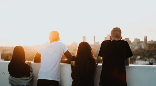 Young people overlooking cityscape