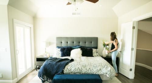 Woman_placing_vase_in_bedroom