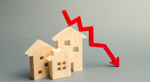 Red downward arrow behind small wooden houses