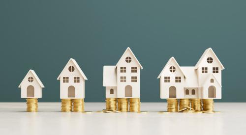 White houses growing in size on stacks of coins