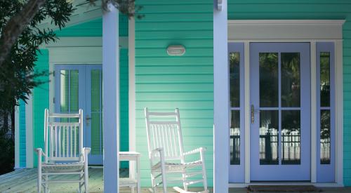 House exterior with front porch and rocking chairs