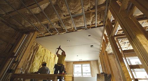 Workers installing drywall 