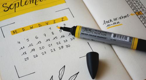 September calendar with highlighter on table