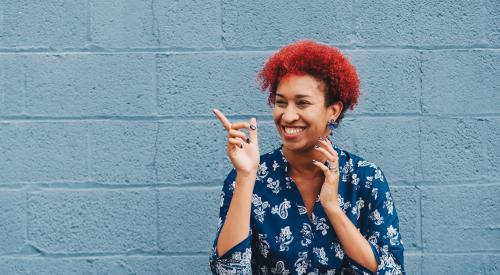 Woman in front of blue wall