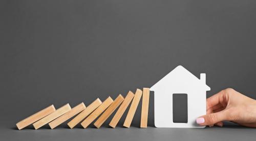 Dominoes falling on house cutout