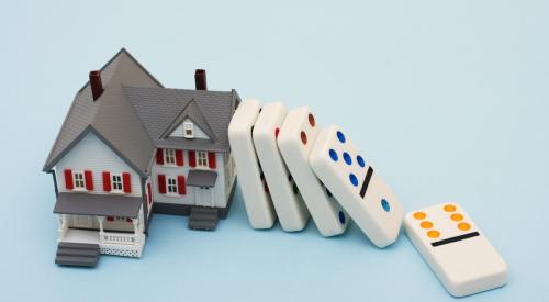 Dominoes falling on replica house