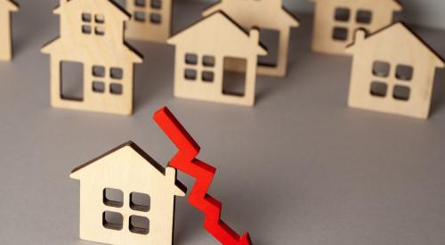 Small wooden houses with bright red falling arrow