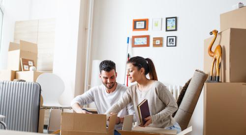 Family unpacking boxes in new home