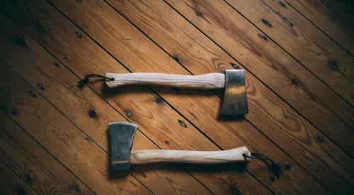 Two axes on wooden board