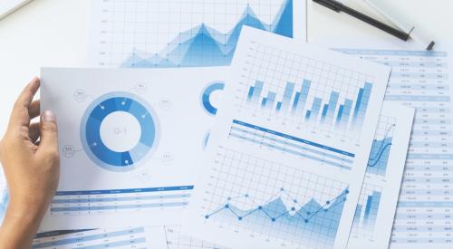 Financial bar, pie, and line charts spread out on table for review