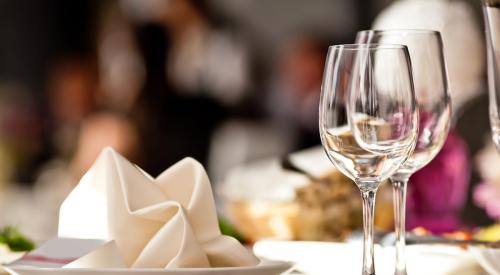 White napkins and wine glasses on table