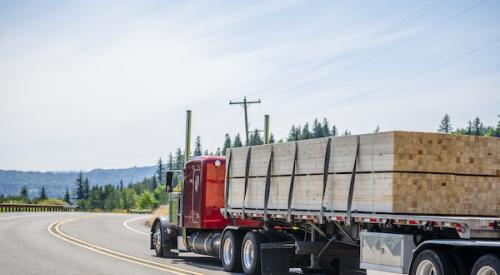 Flat-bed truck hauling lumber