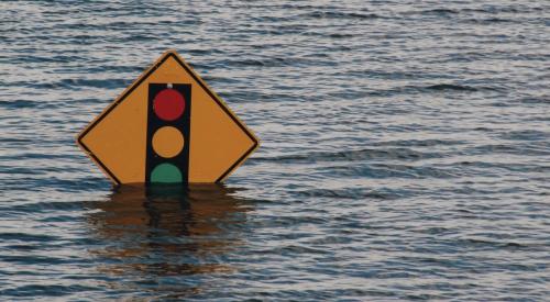 Street flooding covering traffic sign