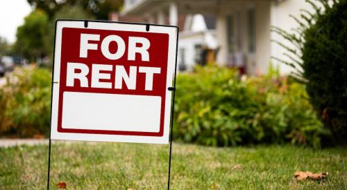 Red and white for-rent sign outside of house