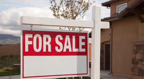 Red and white for sale sign in lawn