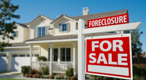 Foreclosure sign in front yard of home