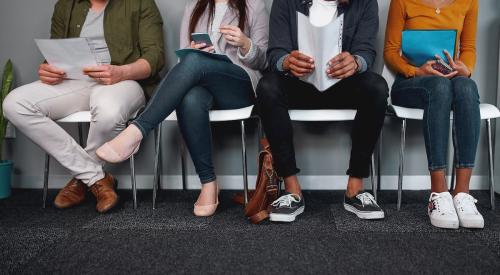 People sitting on chairs waiting for job interview