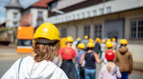 Girls in construction hard hats learning new skills