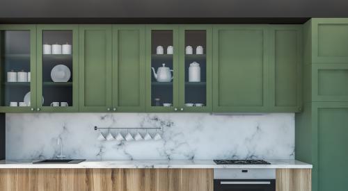 Modern kitchen with marble countertops and green cabinets