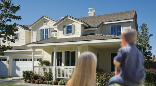 Family looking at a house exterior