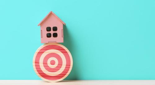 Small wooden house on top of target 