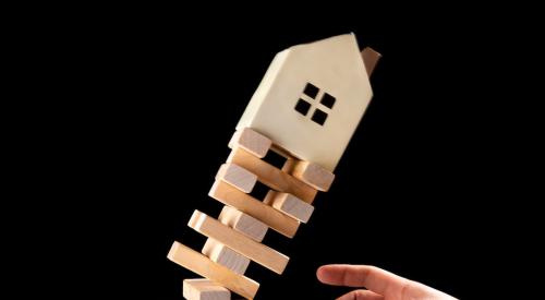 House on top of falling Jenga pillar