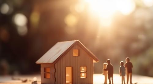 Small wooden house model with figurines outside