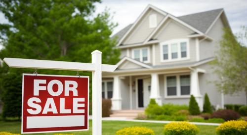 Residential home with red and white for sale sign on lawn