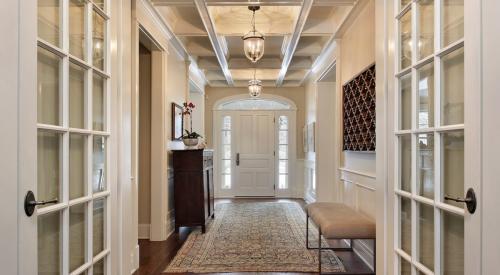 House foyer with glass french doors and bright accents 