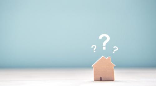 Wooden house surrounded by white question marks with blue background