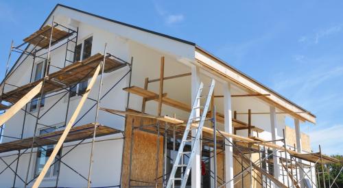 Home exterior with scaffolding under renovation