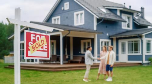 Sold sign in lawn outside of residential home