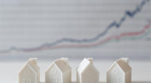 Four white houses in front of line graph trending upwards