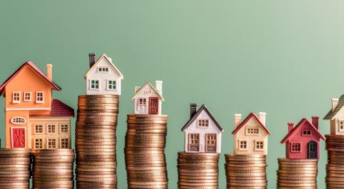 Houses stacked on piles of coins 