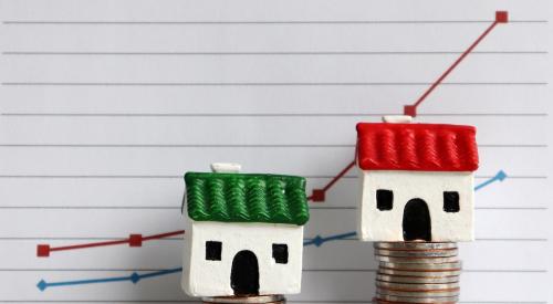 Houses on uneven stacks of coins against line graph