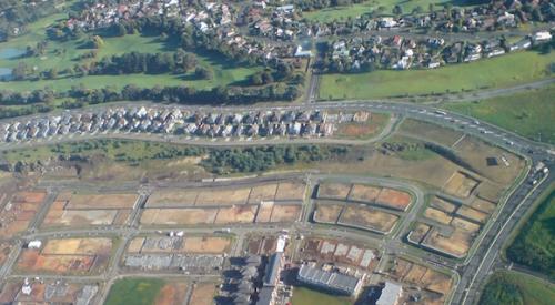 Aerial view of a housing subdivision with part complete and part still under construction.