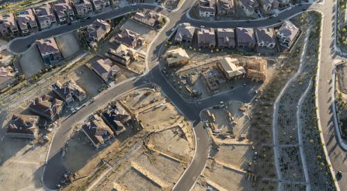 aerial view of housing development with some houses built and other empty lots ready for construction