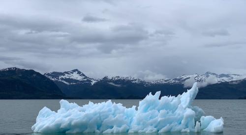 iceberg floating in water affected by climate change