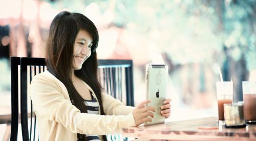 A woman using an iPad for a home sales call