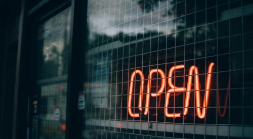 Illuminated 'open' sign in a window