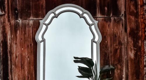 Mirror on hay bale with candles and plants