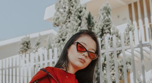 Fashionable woman standing in front of home