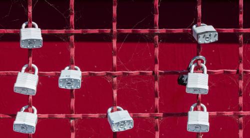 Locks on red fence