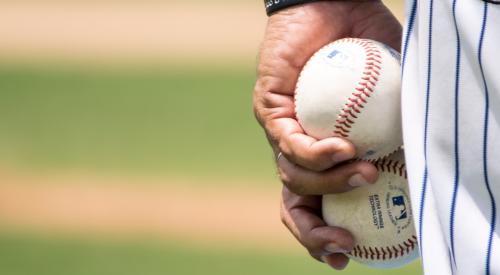 Pitcher with two baseballs in his hand