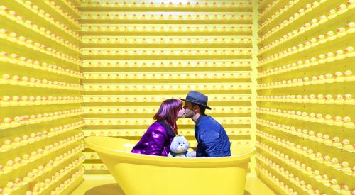 Couple in bathtub with care bear plush