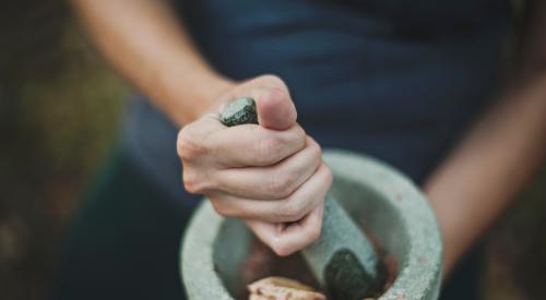 Woman using mortar and pestle