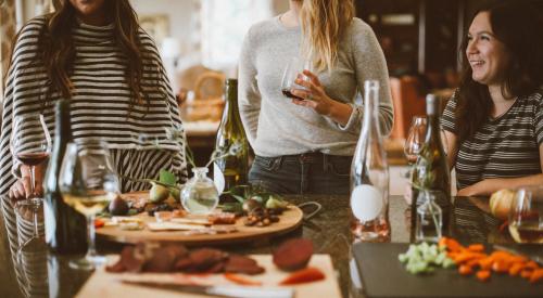 Women enjoying drinks together at dinner table