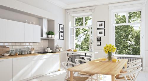 White kitchen with black and white rug accent and large windows