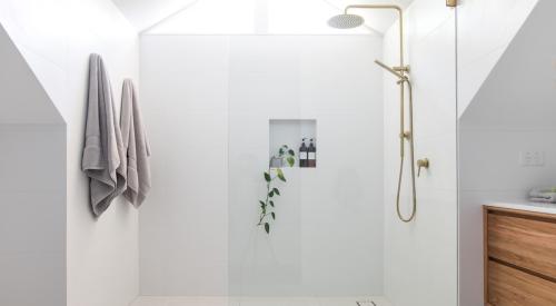 Large glass shower in white modern bathroom