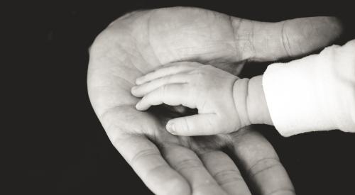 Black and white photo of two hands